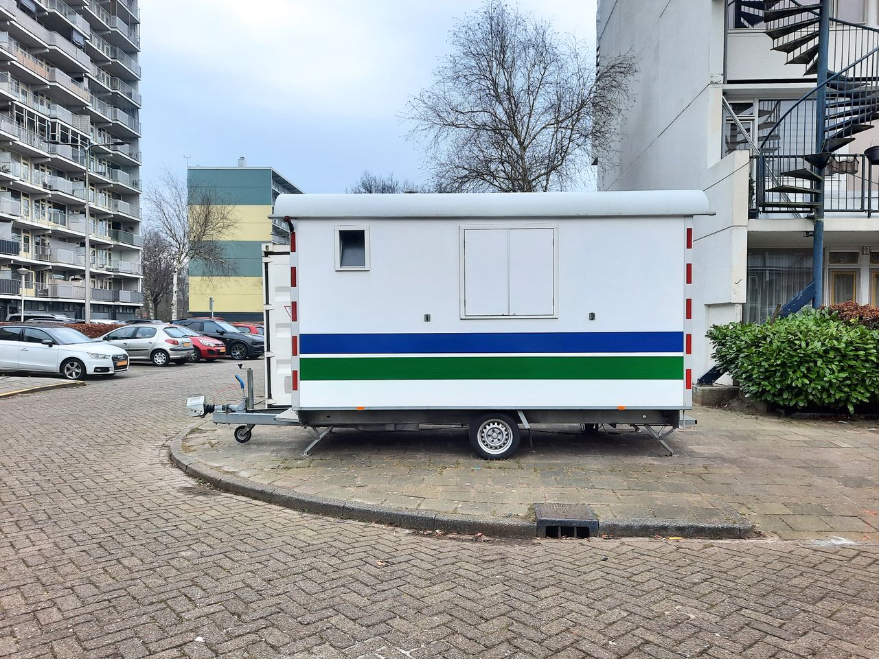 Crafting Captivating Headlines: Your awesome post title goes here A white mobile trailer parked in an apartment complex parking lot.